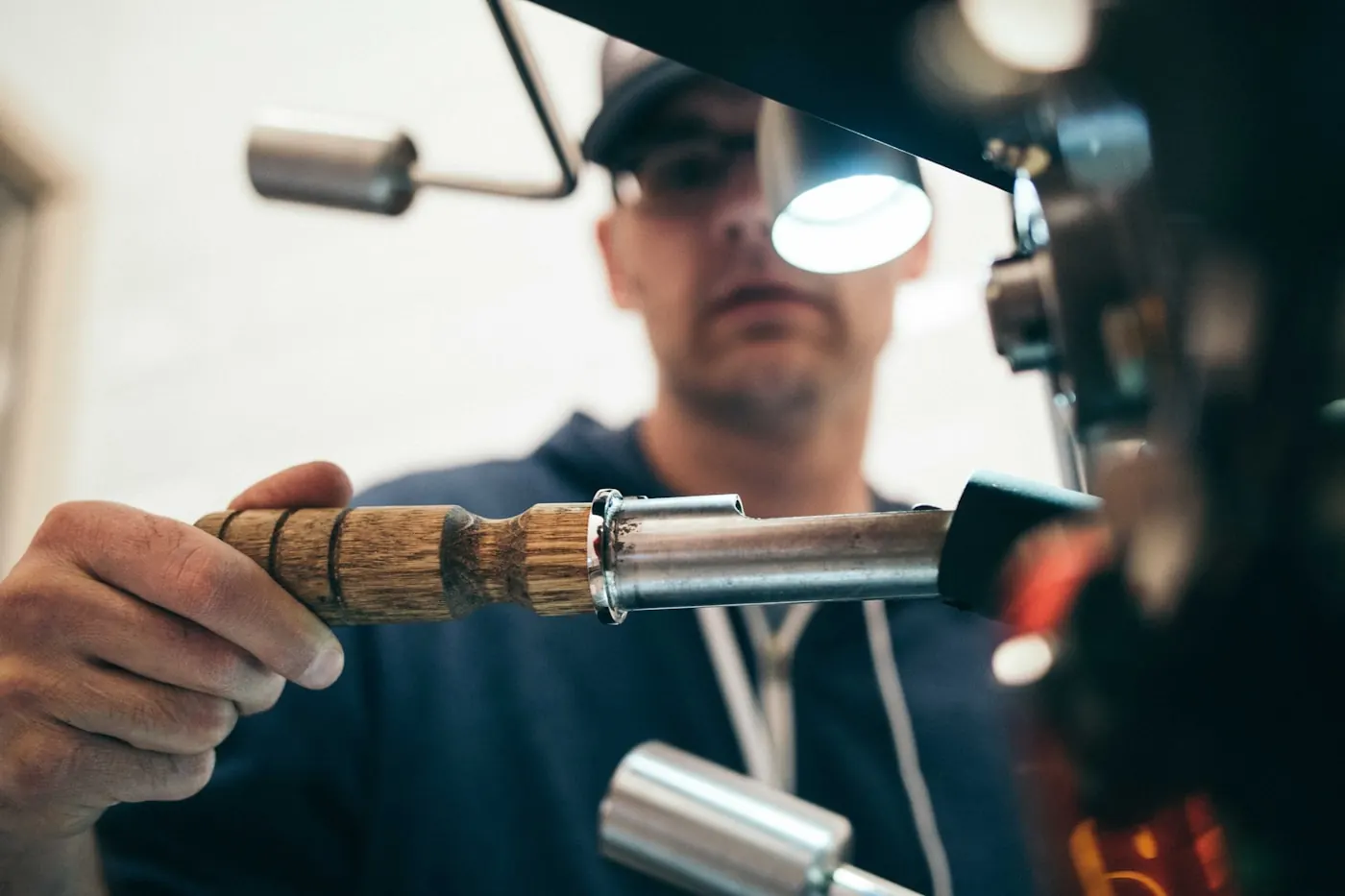 Technician using a hand tool while servicing mechanical equipment