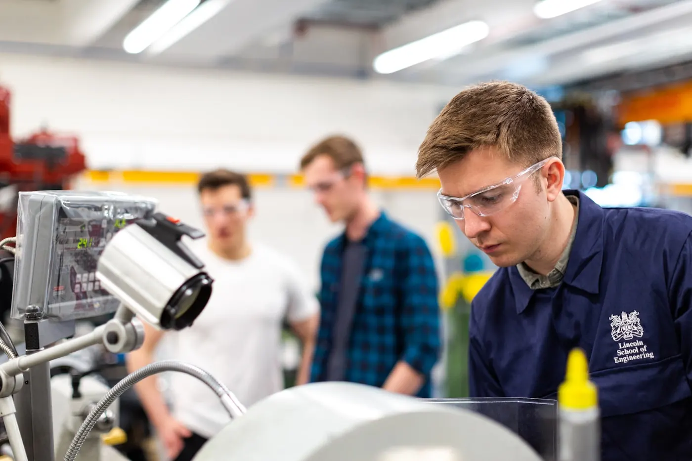 Technician inspecting precision equipment in a professional workshop